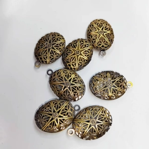 Vintage bronze oval hollow locket pendant with sunburst star pattern for DIY jewelry