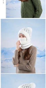Detail of white winter knit hooded hat with pom-pom and integrated face mask on a model