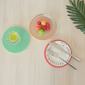 Close-up of heat-resistant silicone honeycomb table mats in three patterns on wood