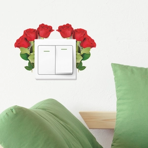 Detailed view of red rose wall stickers around a white light switch in home decor