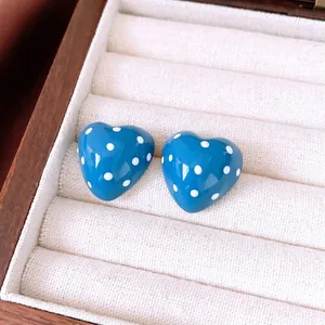 Blue heart stud earrings with white polka dots in a velvet gift box display