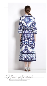 Back view of a long midi dress with blue and white porcelain print and elbow sleeves