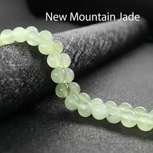 Macro detail of natural light green Shanshan jade beads with smooth polished texture