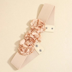 Close-up of pink elastic waist belt featuring 3D fabric flower and metal snap button