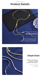 Detail of elegant gold and silver snake bone chain necklaces displayed on velvet surface