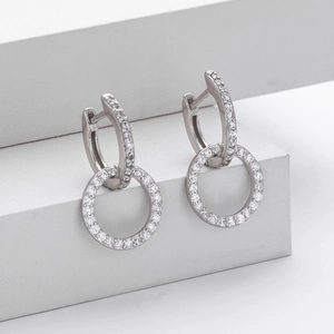 Detail shot of interlocking silver double hoop earrings with pave set zirconia crystals