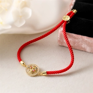Adjustable red rope bracelet with gold Tree of Life pendant featuring zircon stones