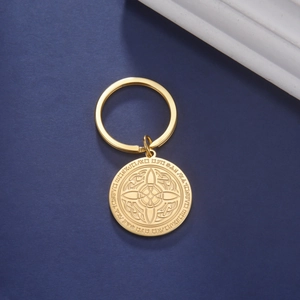 Detailed close-up of golden stainless steel keychain with Celtic knot and rune engraving