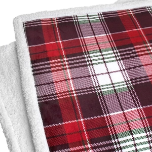 Close-up of red plaid flannel blanket showing soft white Sherpa fleece texture