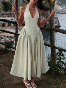 Elegant light green halter midi dress for women featuring soft fabric with a scenic beach view