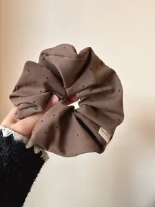 Detailed view of handmade coffee brown fabric scrunchie with sparkling rhinestones