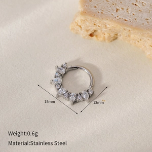 Macro shot of stainless steel nose ring with cubic zirconia showing 15mm and 13mm size details