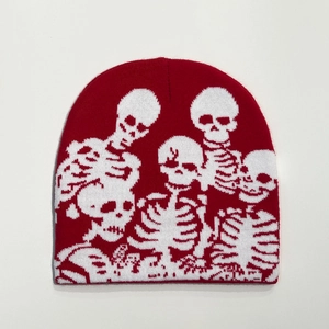 Detailed texture of red knitted beanie featuring white skull jacquard patterns