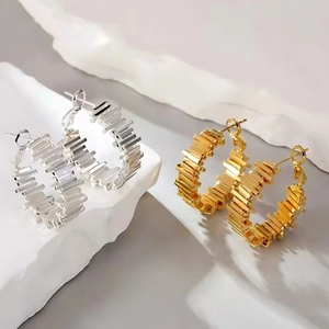Minimalist C-shaped geometric hoop earrings in gold and silver with tiered metal layers