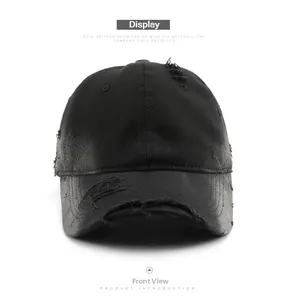 Front view of black distressed cotton baseball cap with ripped details and retro style