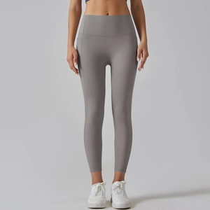 Detail of high-waist grey yoga pants featuring side pockets and seamless stitching