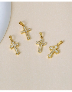 Close-up of golden cross pendants with white zircon stones for jewelry DIY making