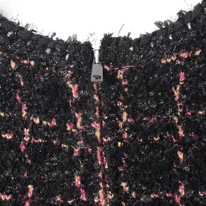 Vista macro dell'abitino in maglia testurizzata con tweed e zip metallica dettagliata