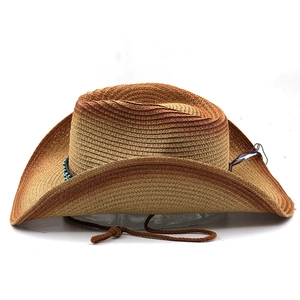 Detail of western straw cowboy hat featuring blue beaded band and adjustable chin strap