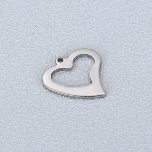 Macro shot of silver hollow heart-shaped stainless steel pendant with connector ring
