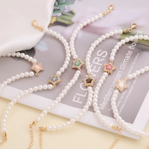 Star charm pearl bracelets with colorful zircons in pink, blue and green on white silk