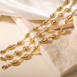 Minimalist 18K gold plated stainless steel bracelet with mixed geometric charms on white silk