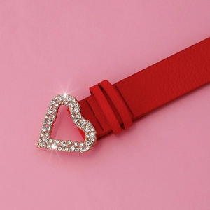 Detail of red PU leather belt featuring a gold heart buckle with sparkling rhinestones