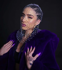 Detailed view of elastic fishnet headpiece with shiny rhinestones and mesh design