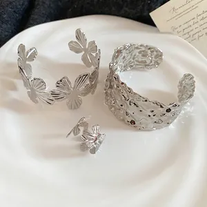 Silver metal floral cutout bangle set with irregular hammer texture ring and bracelet