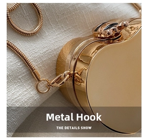 Close-up of golden heart evening bag showing the premium metal hardware and chain