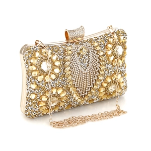Close-up of evening clutch featuring intricate gold rhinestones and amber crystal accents