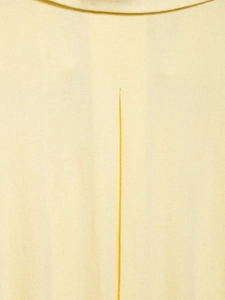 Close-up detail of light yellow linen blend fabric texture and back seam stitching