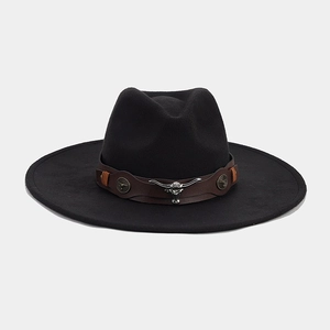 Detail of black wide brim wool fedora hat featuring brown leather band and metal bull head