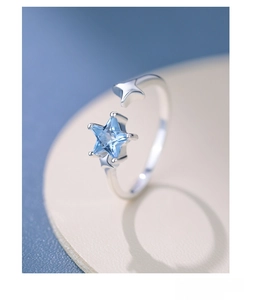 Macro shot of S925 sterling silver ring with blue star zircon and adjustable band