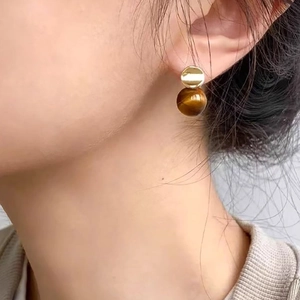 18k gold plated tiger eye earrings on model showcasing a minimalist geometric design