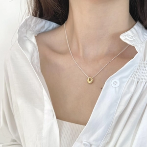 Minimalist 925 sterling silver oval ring pendant necklace worn by model on white shirt
