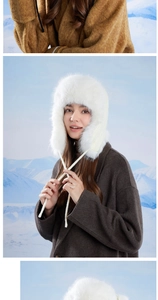 Detailed texture of white faux fur earflap hat with fluffy plush lining and long drawstrings