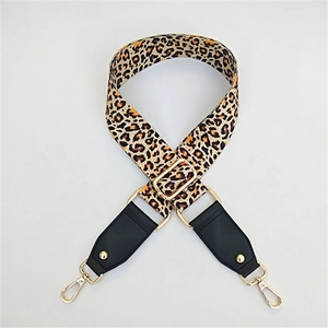 Detail of adjustable leopard print bag strap with gold metal hooks and black leather ends