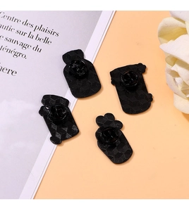 Detailed back view of enamel pins featuring geometric texture and black rubber clutches