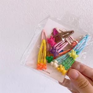 Detailed macro view of colorful mini resin bears on matte BB hair clips in a pack