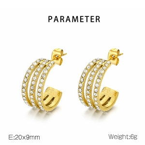 Detail view of gold C-shaped earrings with zircon inlay including 20x9mm size parameters