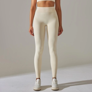 Close-up of seamless high-waist yoga pants in cream white with supportive knit texture