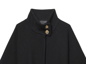 Close-up of black wool coat featuring high collar and premium golden metal buttons