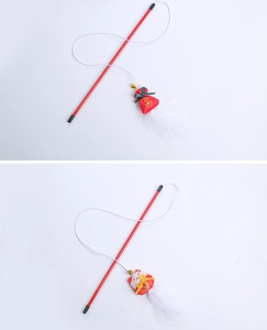 Detail of red cat wand toy with bell, white feathers, and fortune pouch pendant