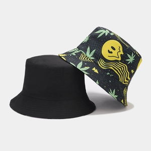Close-up of reversible bucket hat with yellow melting smile and green leaf pattern print