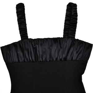Detail of black square neck dress featuring ruffled satin straps and pleated chest texture