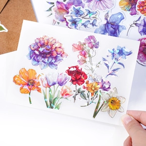Close-up of holographic floral stickers with laser reflection on flowers and leaves