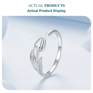 Detailed side view of silver tulip open ring featuring delicate flower and leaf design