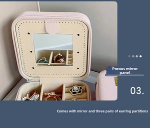 Close-up of pink jewelry box with built-in mirror and earring storage panel