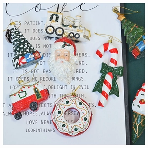Detailed flat lay of festive Christmas resin ornaments on vintage script paper background